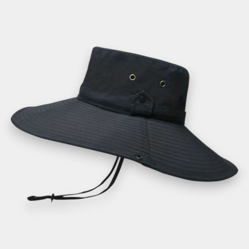 Black wide brimmed hat with a tie on a light gray background